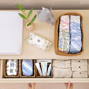 Geo Mood 72 Count pack of Honest baby wipes on surface next to basket of Honest Diapers and drawer of Honest diapers and various personal care items