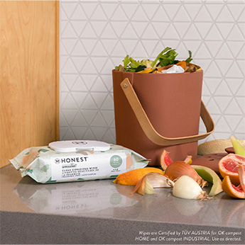 Geo Mood 72 Count pack of Honest baby wipes on counter next to compost bin and orange peels